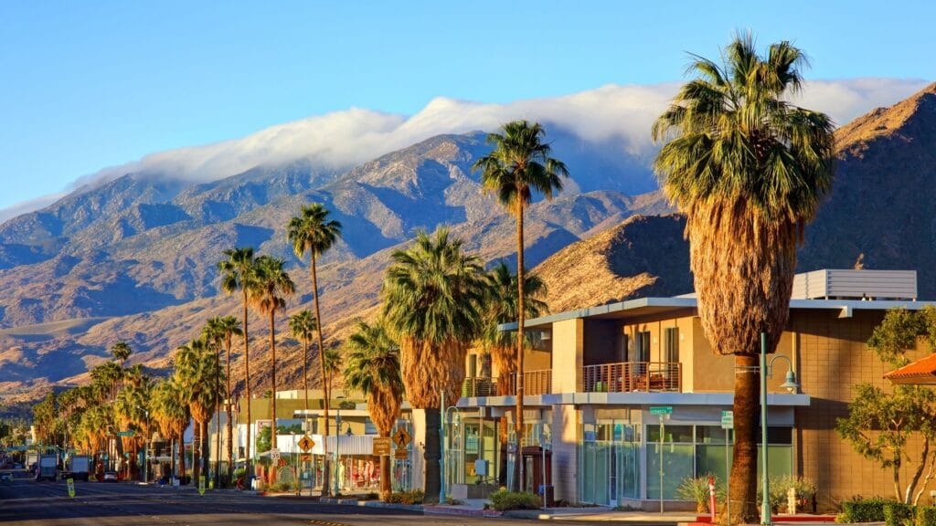 Palm Springs downtown main street, featuring majestic palm trees with a backdrop of Mount San Jacinto, near the Casa Oliver Hotel & Resort.