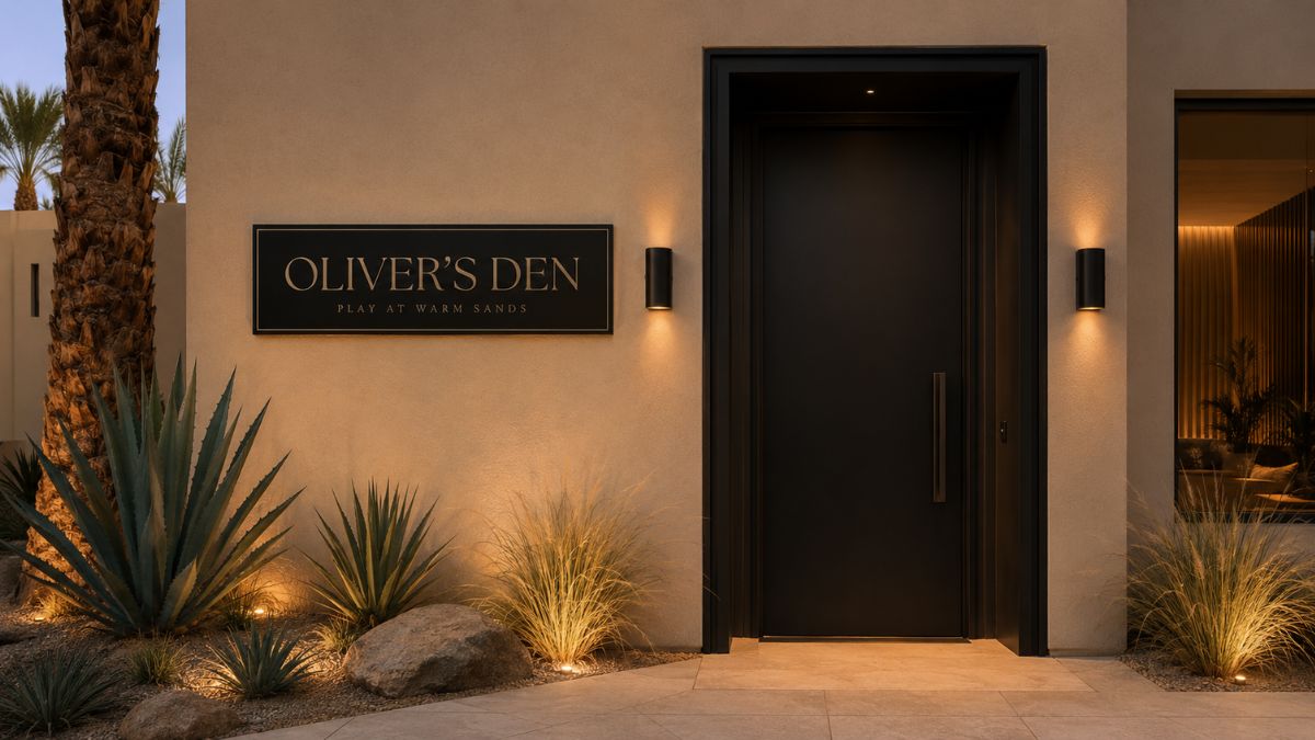 Conceptual Oliver’s Den entrance with a black door, beige exterior and desert landscaping at Casa Oliver in Palm Springs.